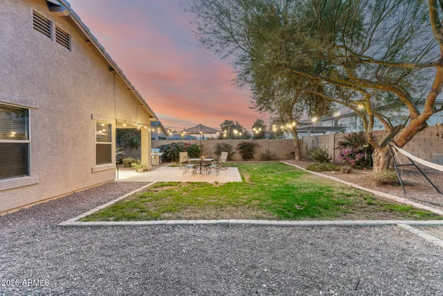 a view of a patio with a table and chairs under an umbrella