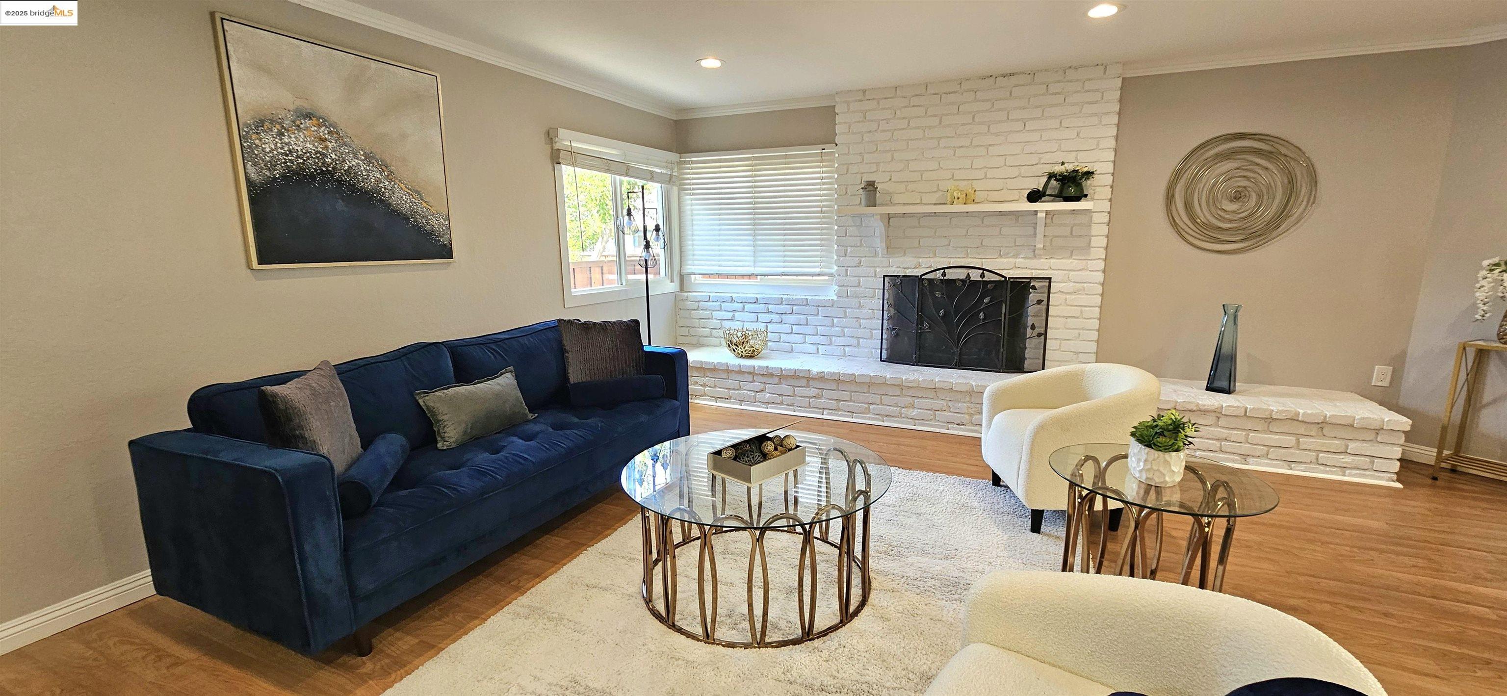 3195 Willow Pass Road Concord, CA 94519 - Photo 11 of 30 a living room with furniture a fireplace and wall paintings