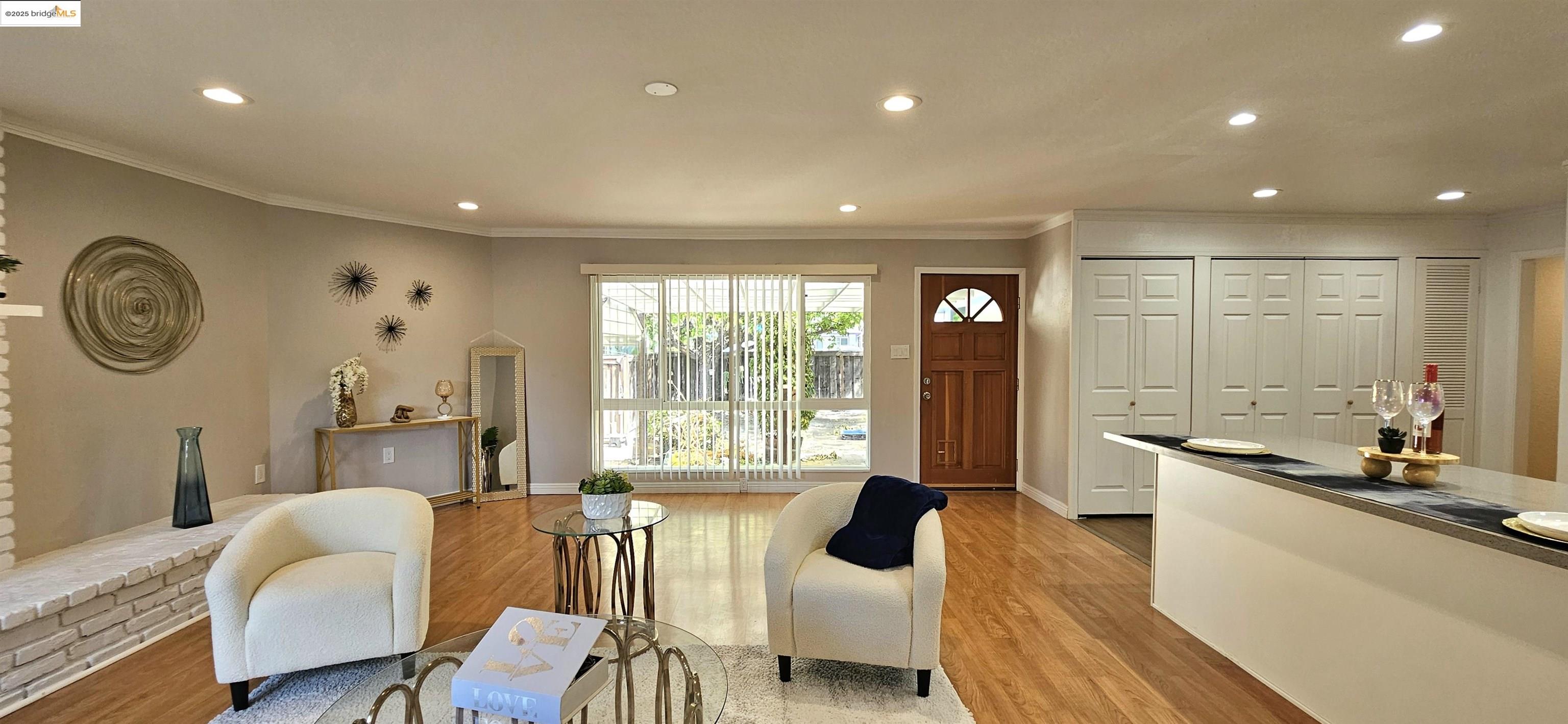 3195 Willow Pass Road Concord, CA 94519 - Photo 12 of 30 a living room with furniture a large window and a clock