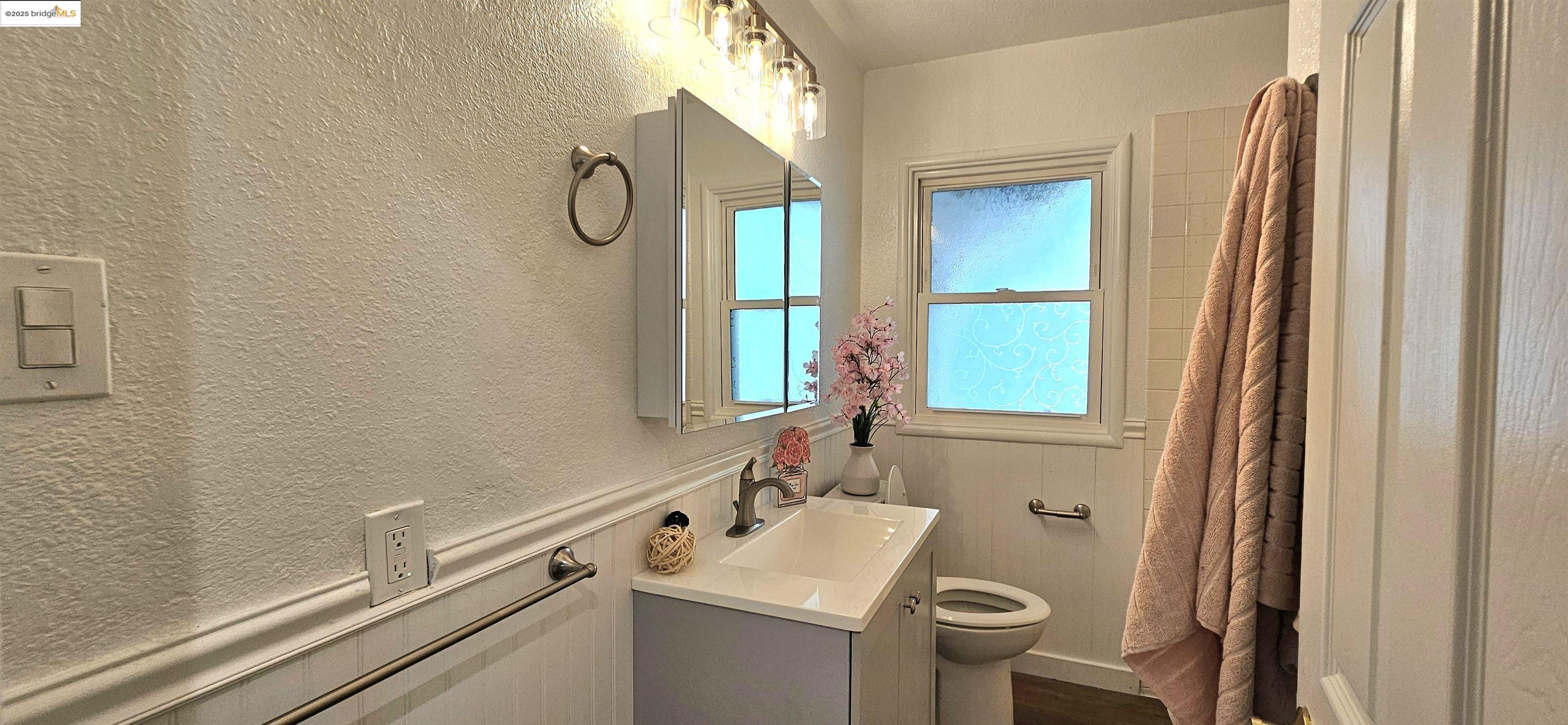 3195 Willow Pass Road Concord, CA 94519 - Photo 15 of 30 a bathroom with a sink vanity mirror and toilet