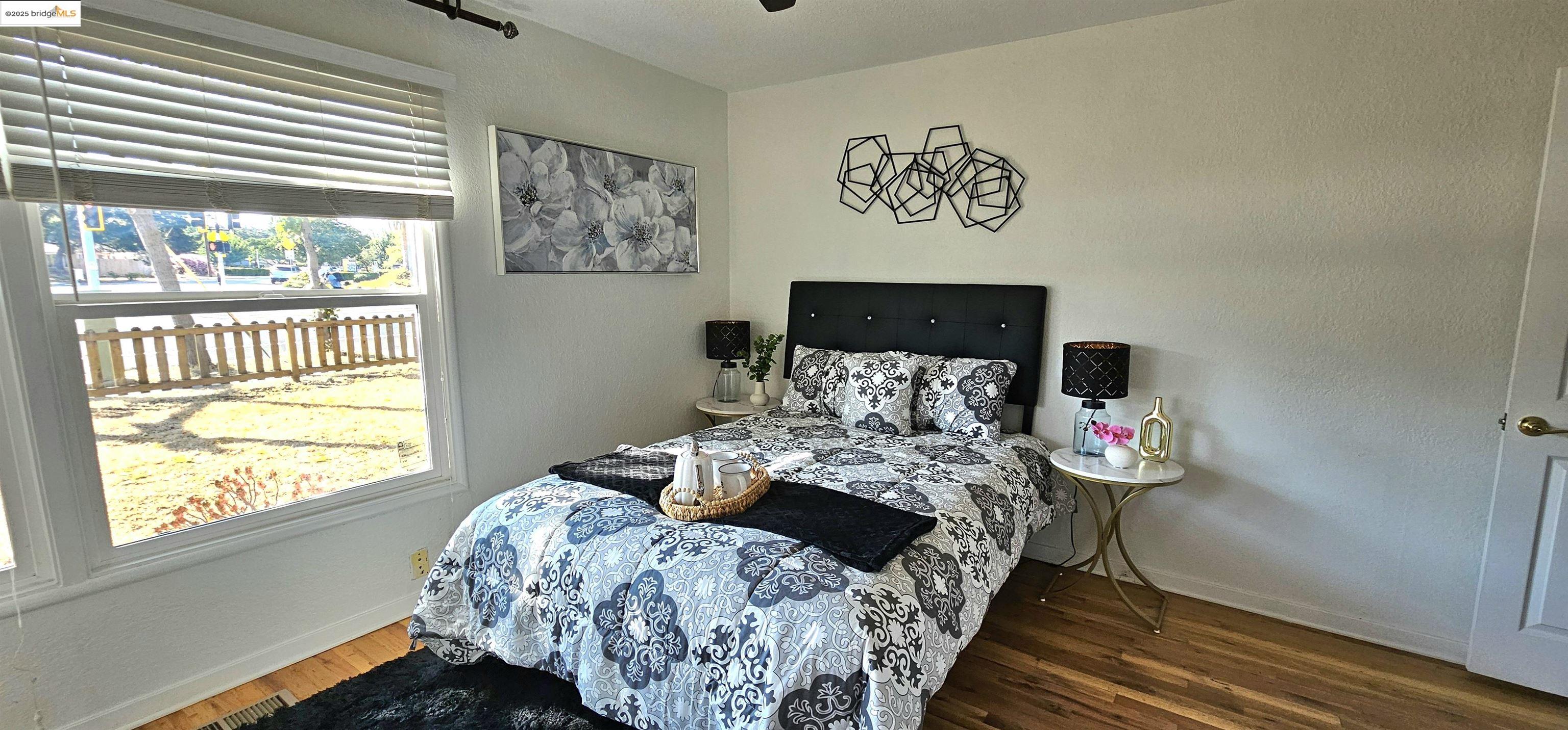 3195 Willow Pass Road Concord, CA 94519 - Photo 17 of 30 a bed sitting in a bedroom next to a window