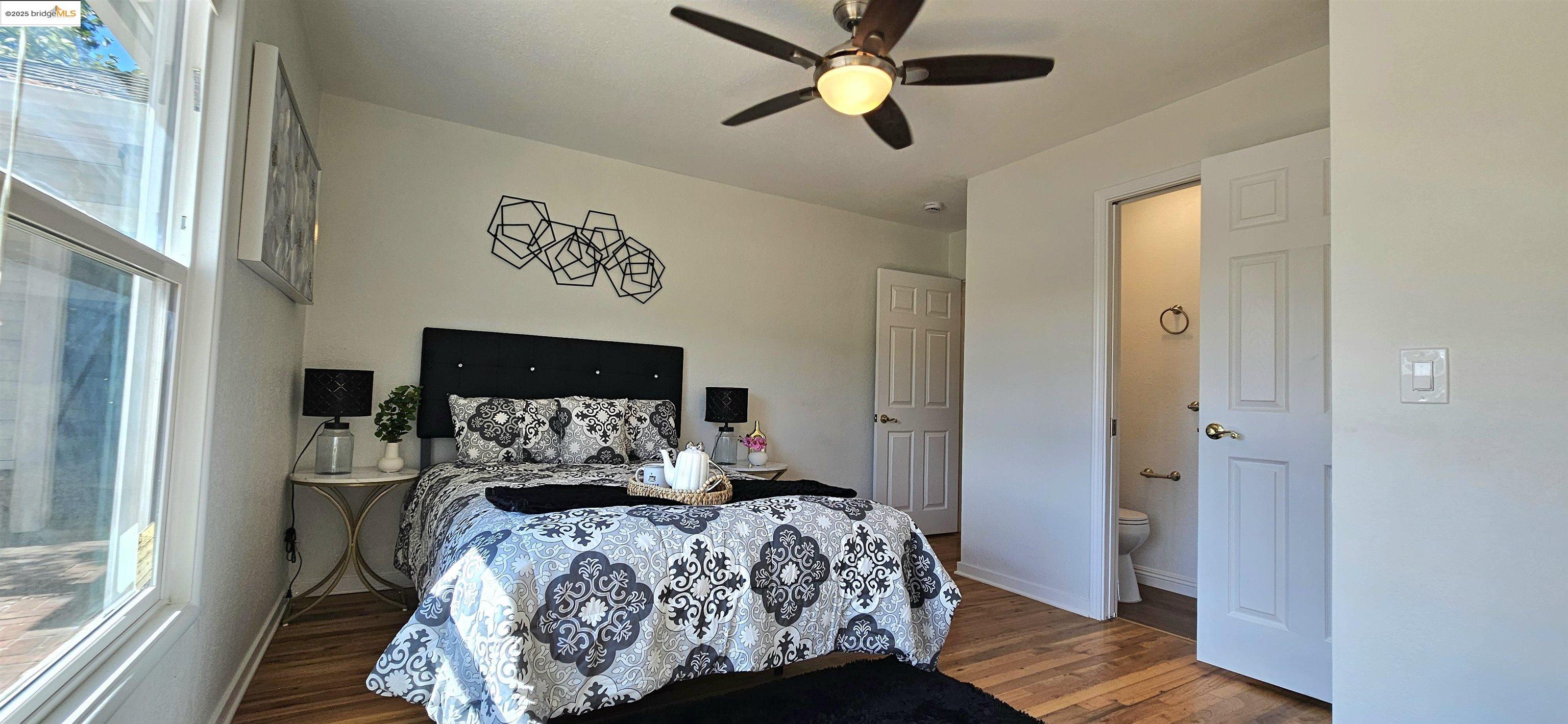 3195 Willow Pass Road Concord, CA 94519 - Photo 18 of 30 a bedroom with a bed and a chandelier