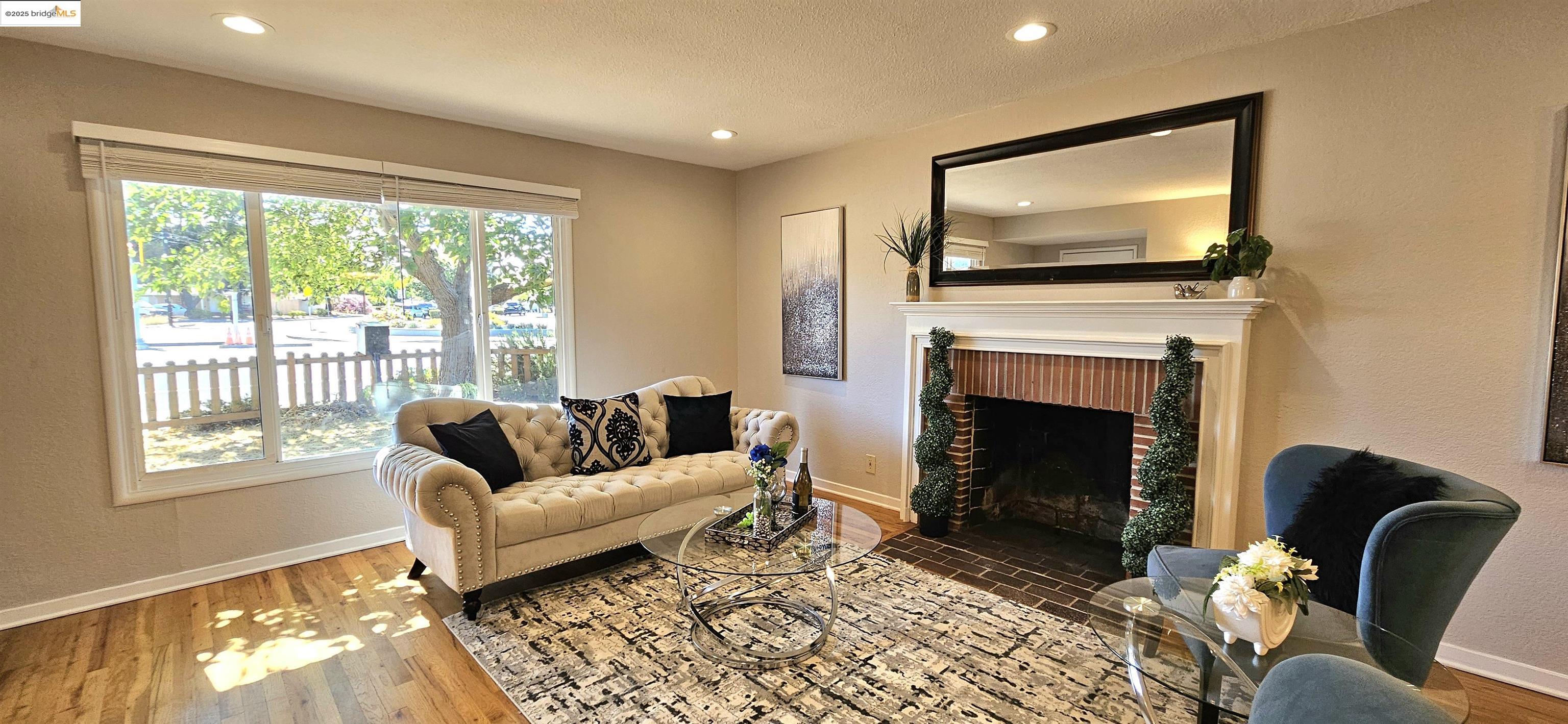 3195 Willow Pass Road Concord, CA 94519 - Photo 3 of 30 a living room with furniture and a fireplace