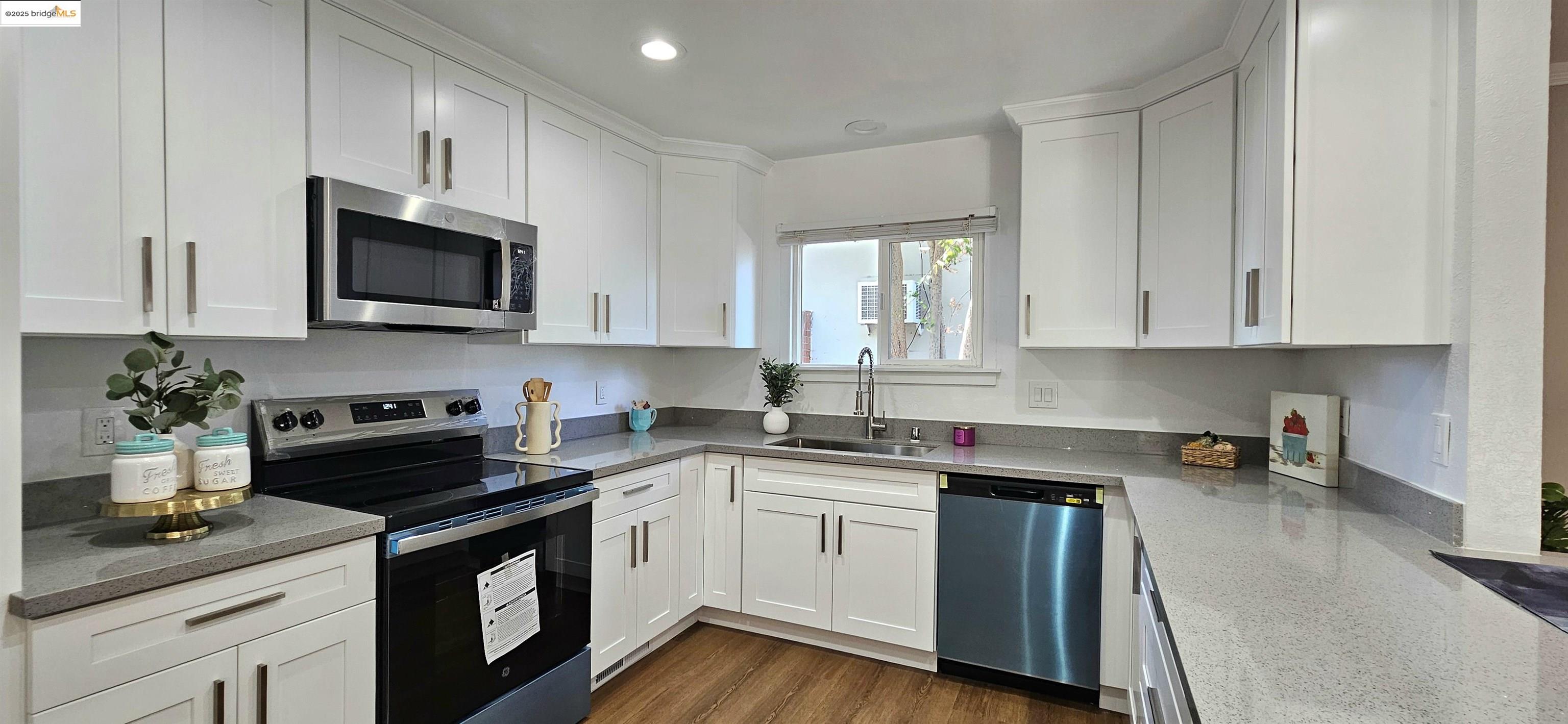 3195 Willow Pass Road Concord, CA 94519 - Photo 7 of 30 a kitchen with stainless steel appliances granite countertop a sink a stove a microwave and cabinets