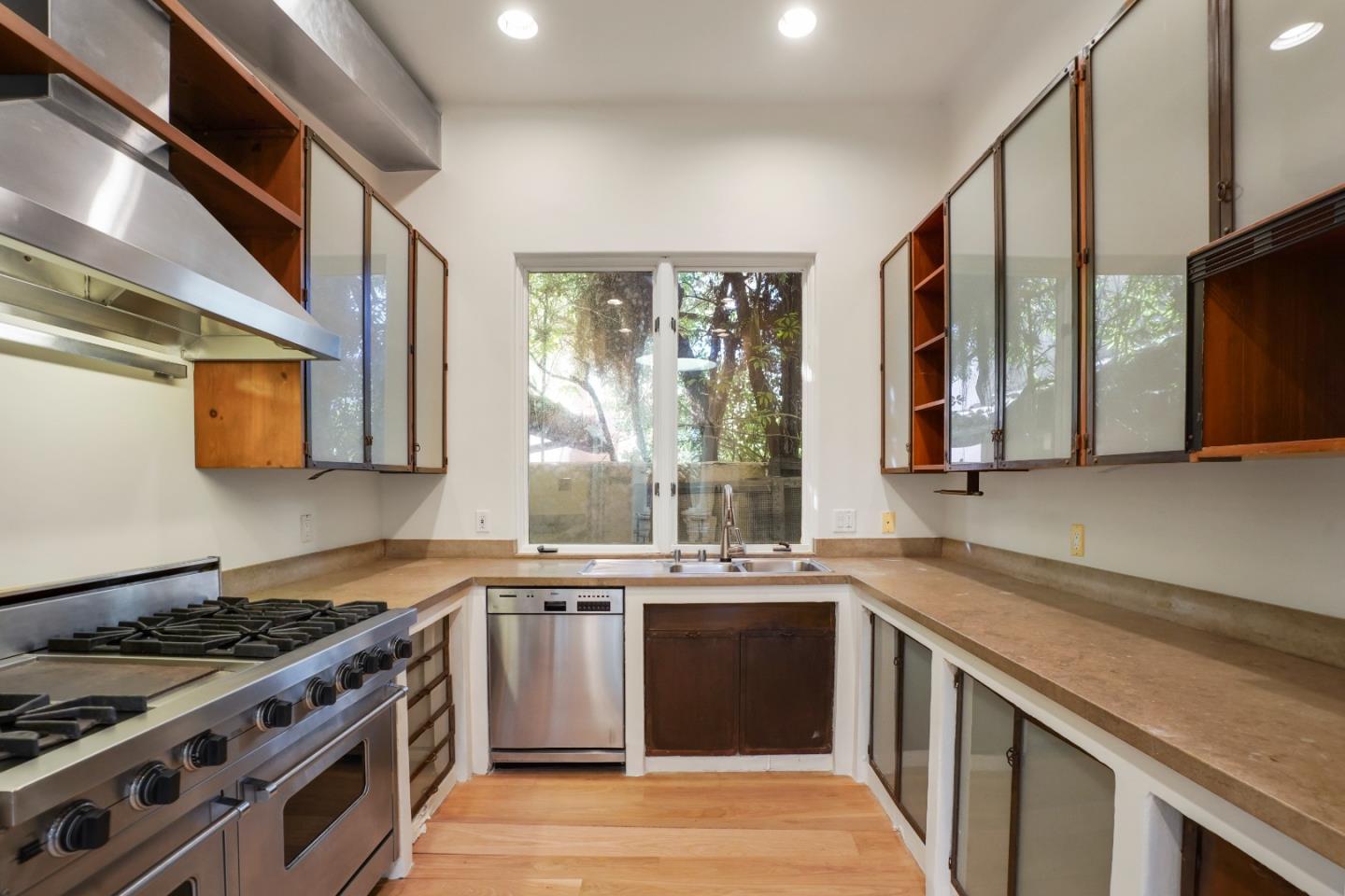 23349 Malibu Colony Road Malibu, CA 90265 - Photo 15 of 43 a kitchen with stainless steel appliances a sink a stove and a refrigerator