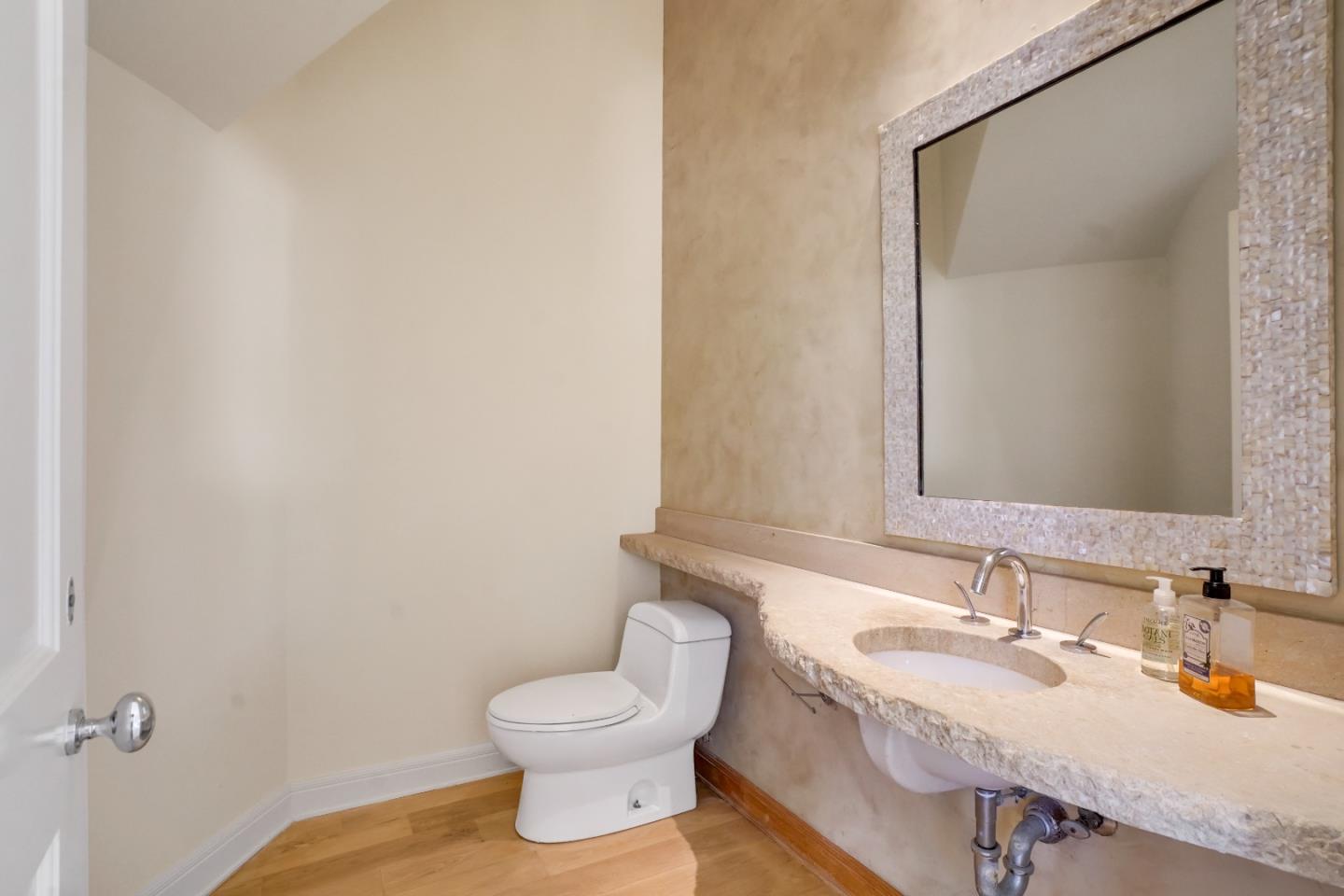 23349 Malibu Colony Road Malibu, CA 90265 - Photo 18 of 43 a bathroom with a granite countertop sink toilet and mirror