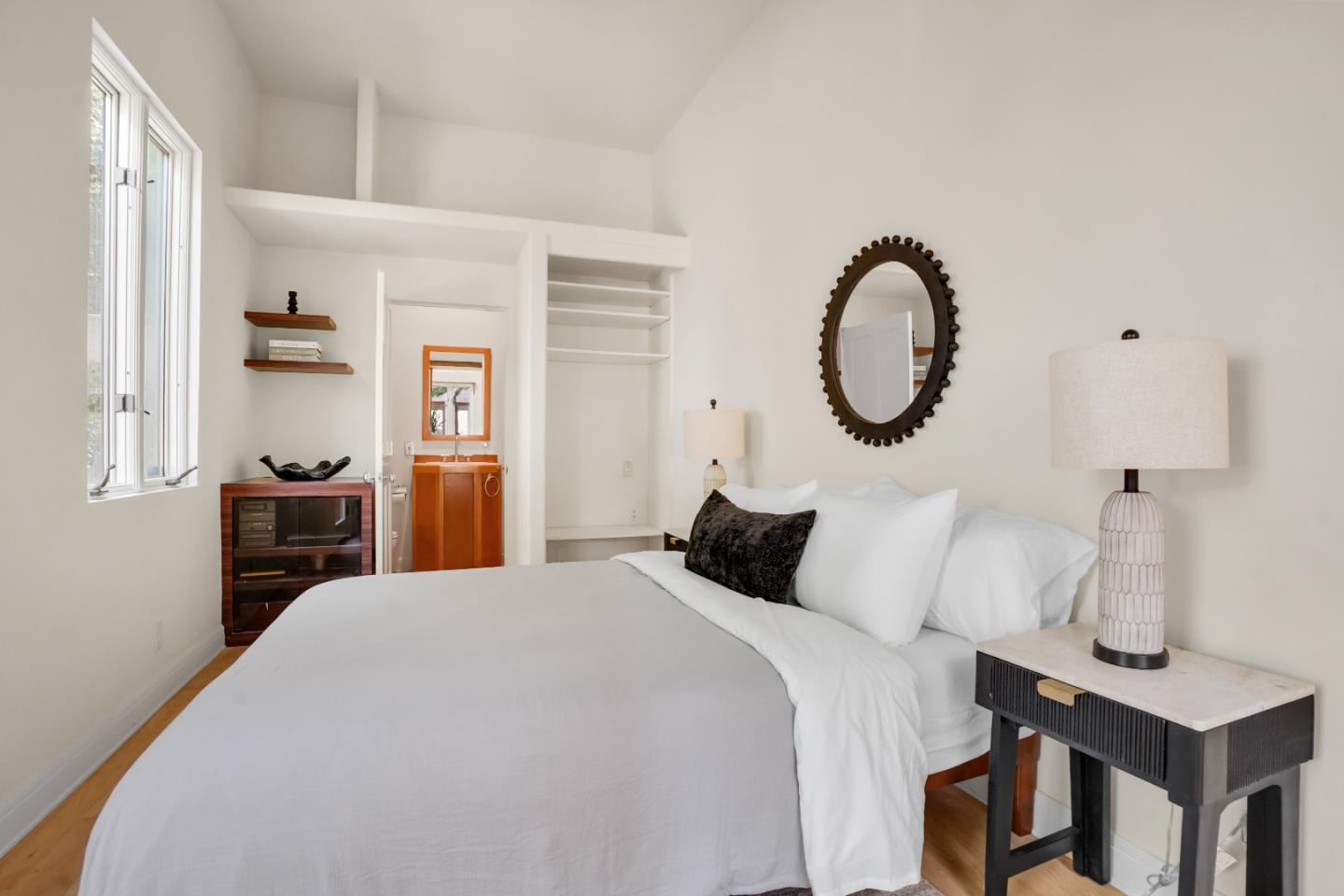 23349 Malibu Colony Road Malibu, CA 90265 - Photo 19 of 43 a bedroom with a bed and a chandelier