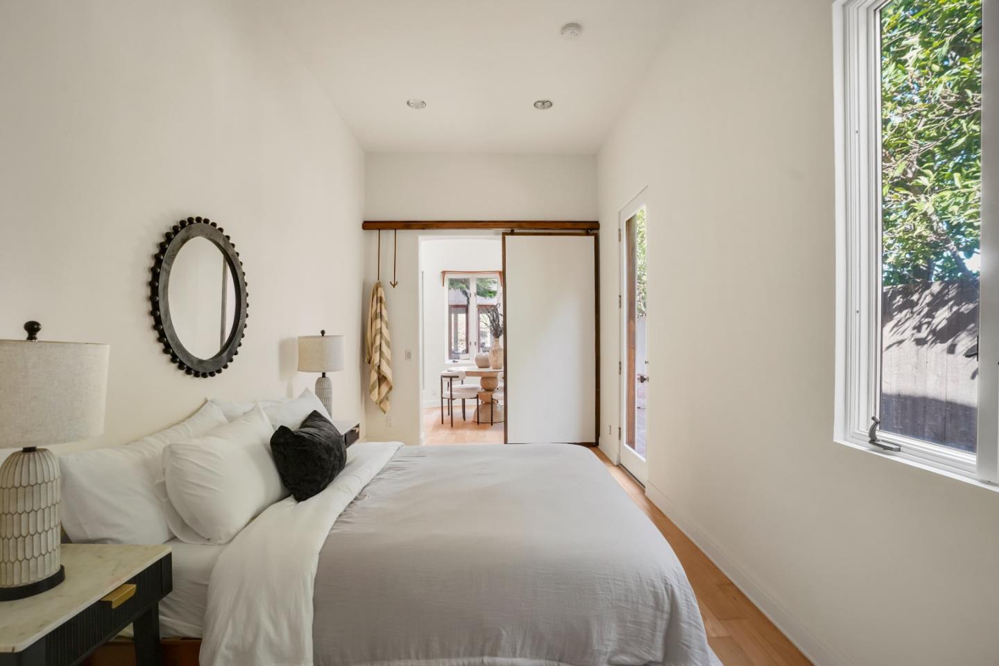 23349 Malibu Colony Road Malibu, CA 90265 - Photo 20 of 43 a bedroom with a bed and a potted plant next to a window