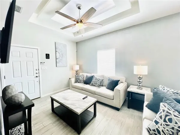 a living room with furniture and wooden floor