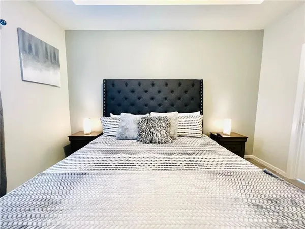 a large bed sitting in a bedroom and chair