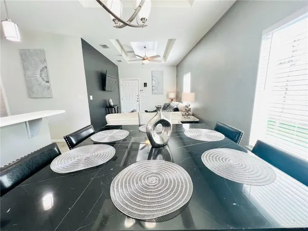 a dining room with furniture a rug and a chandelier