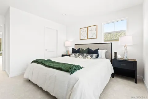 a bedroom with a bed and window