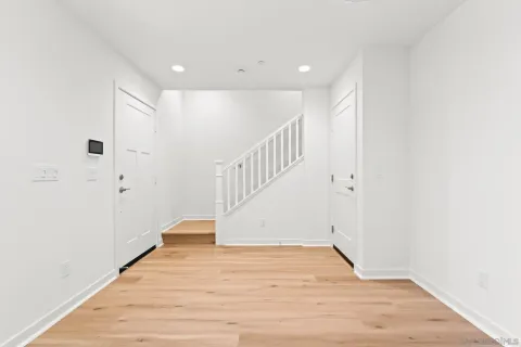 a view of an entryway with wooden floor