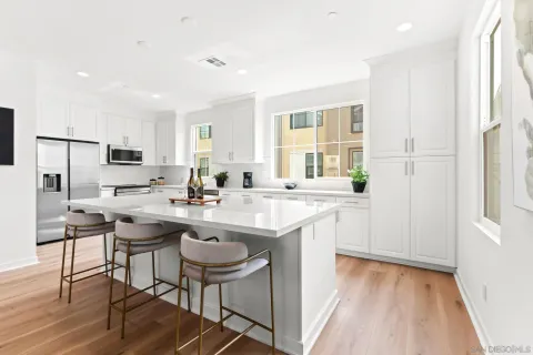 a kitchen with a sink a counter top space and stainless steel appliances