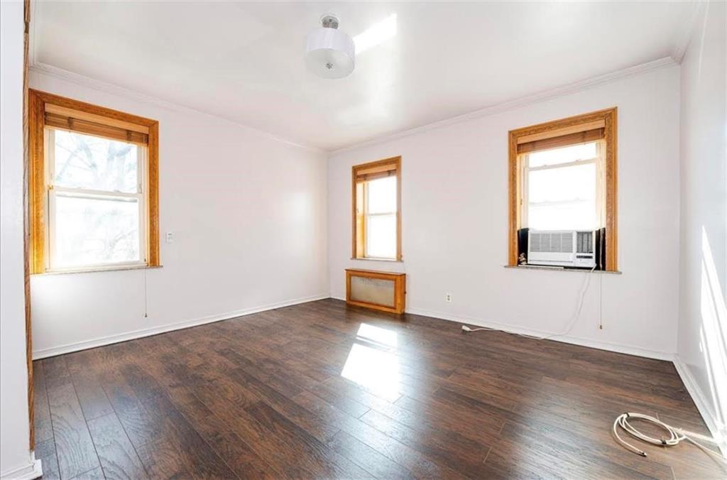 1722 Ave V Brooklyn, NY 11229 - Photo 15 of 28 a view of an empty room with wooden floor and a window