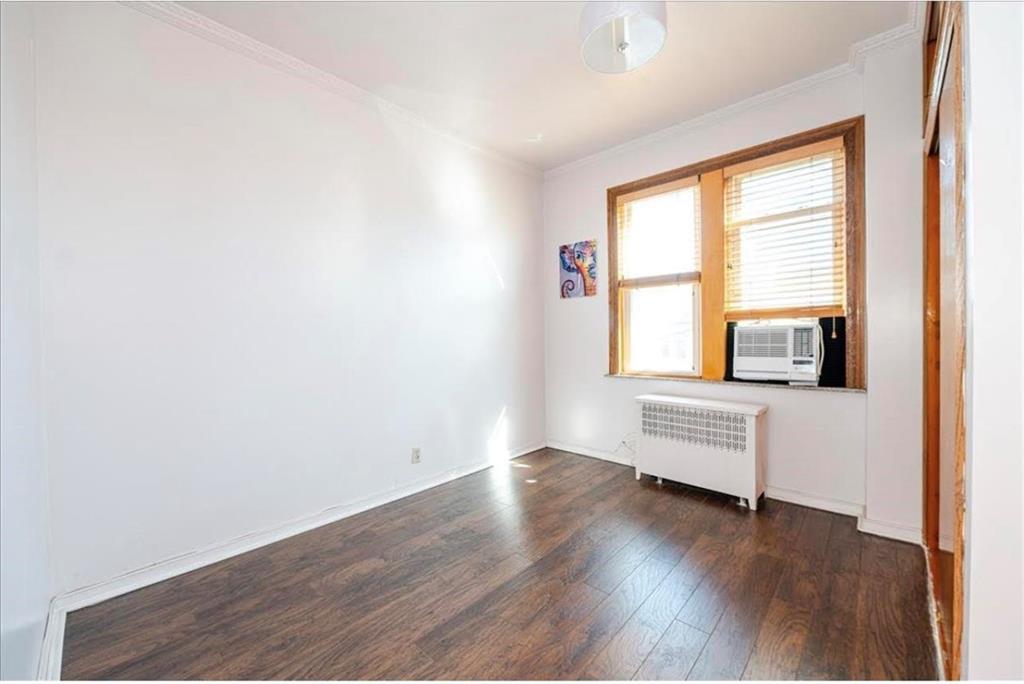 1722 Ave V Brooklyn, NY 11229 - Photo 16 of 28 an empty room with wooden floor and windows