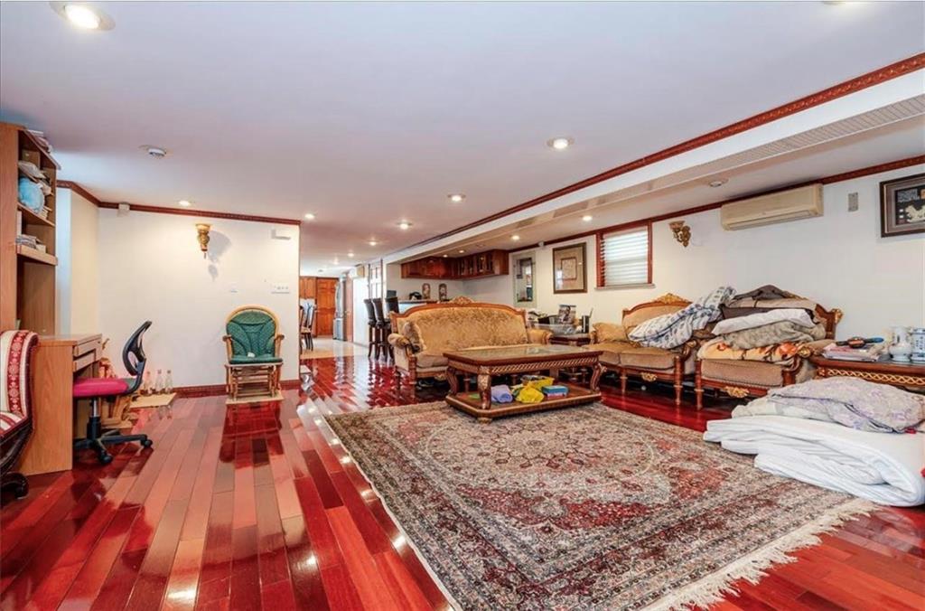 1722 Ave V Brooklyn, NY 11229 - Photo 19 of 28 a living room with lots of furniture and a wooden floor
