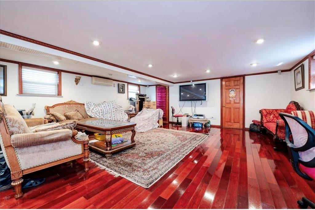 1722 Ave V Brooklyn, NY 11229 - Photo 20 of 28 a living room with furniture and wooden floor