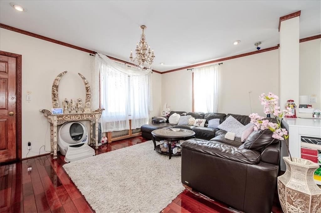 1722 Ave V Brooklyn, NY 11229 - Photo 5 of 28 a living room with furniture a rug and a chandelier