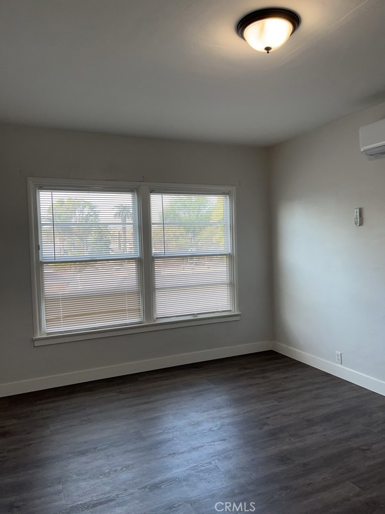 3900 5th Street, Unit 23 Riverside, CA 92501 - Photo 7 of 26 an empty room with wooden floor and windows