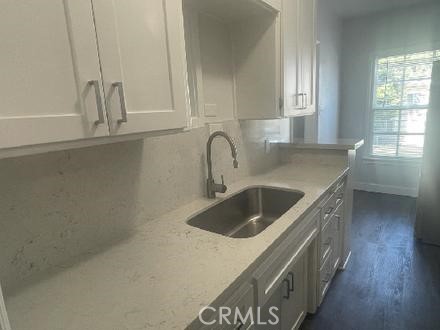 3900 5th Street, Unit 23 Riverside, CA 92501 - Photo 9 of 26 a kitchen with a sink and cabinets