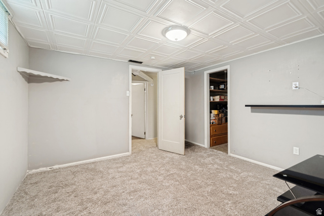 127 West 300 North Springville, UT 84663 - Photo 19 of 24 Bedroom featuring light gray walls, new carpet, a patterned ceiling, and a built-in shelf