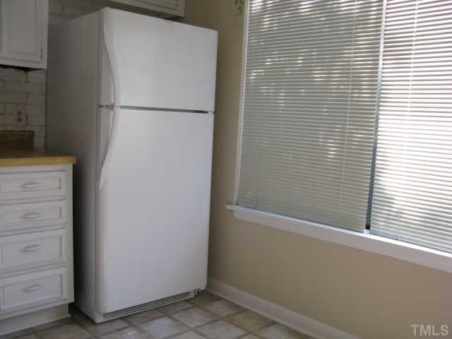 813 Green Ridge Drive Raleigh, NC 27609 - Photo 8 of 22 a white refrigerator freezer and a window