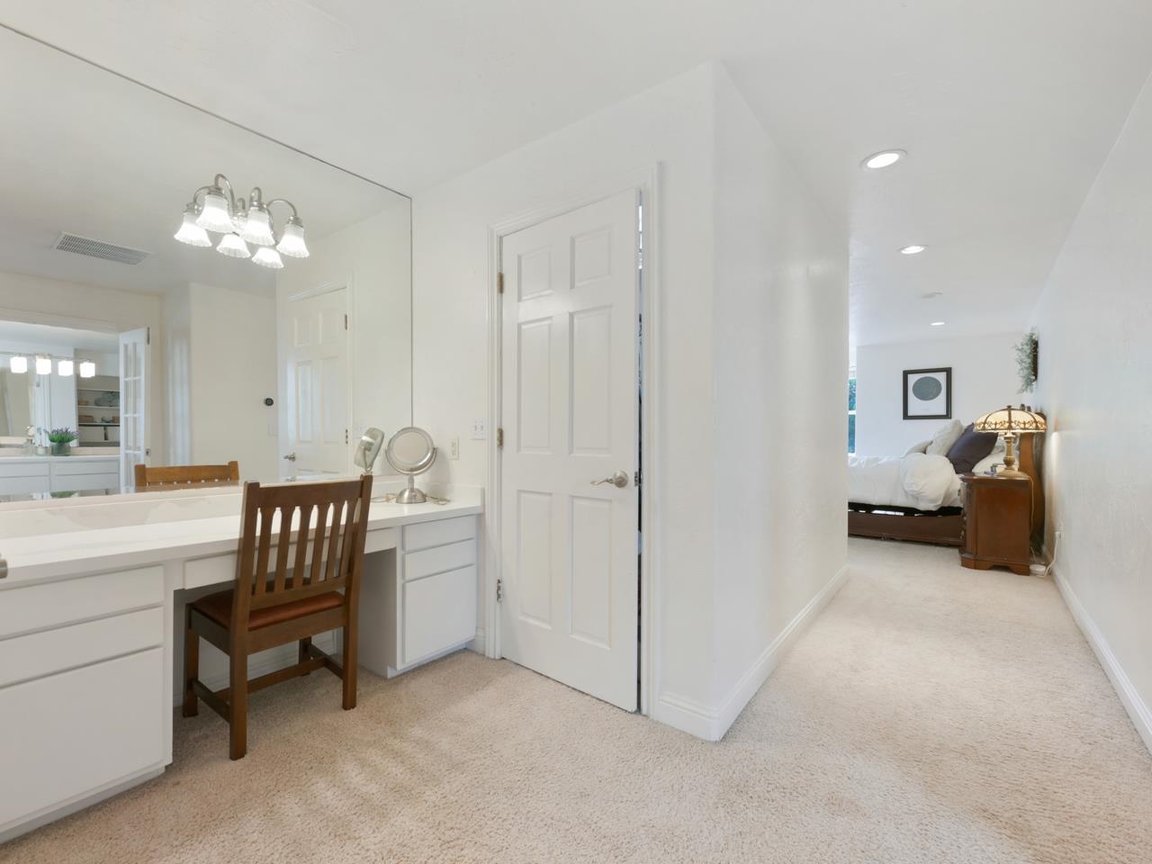 2433 H Road Grand Junction, CO 81505 - Photo 20 of 42 a spacious bedroom with a bed and a chandelier