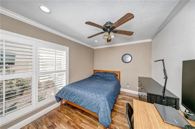 a bedroom with a bed and a large window