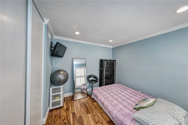 a bedroom with a bed and a flat tv screen