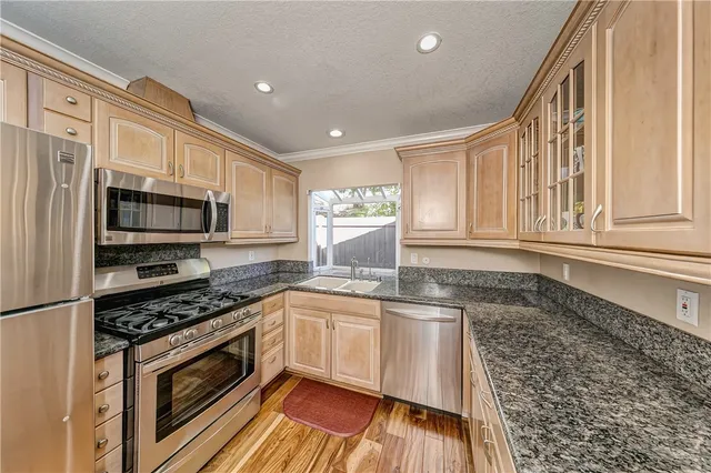 a kitchen with stainless steel appliances a stove sink and microwave
