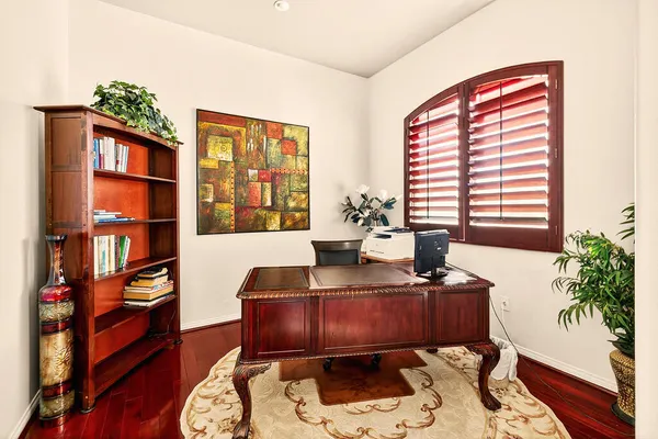 a view of a workspace with furniture and a potted plant