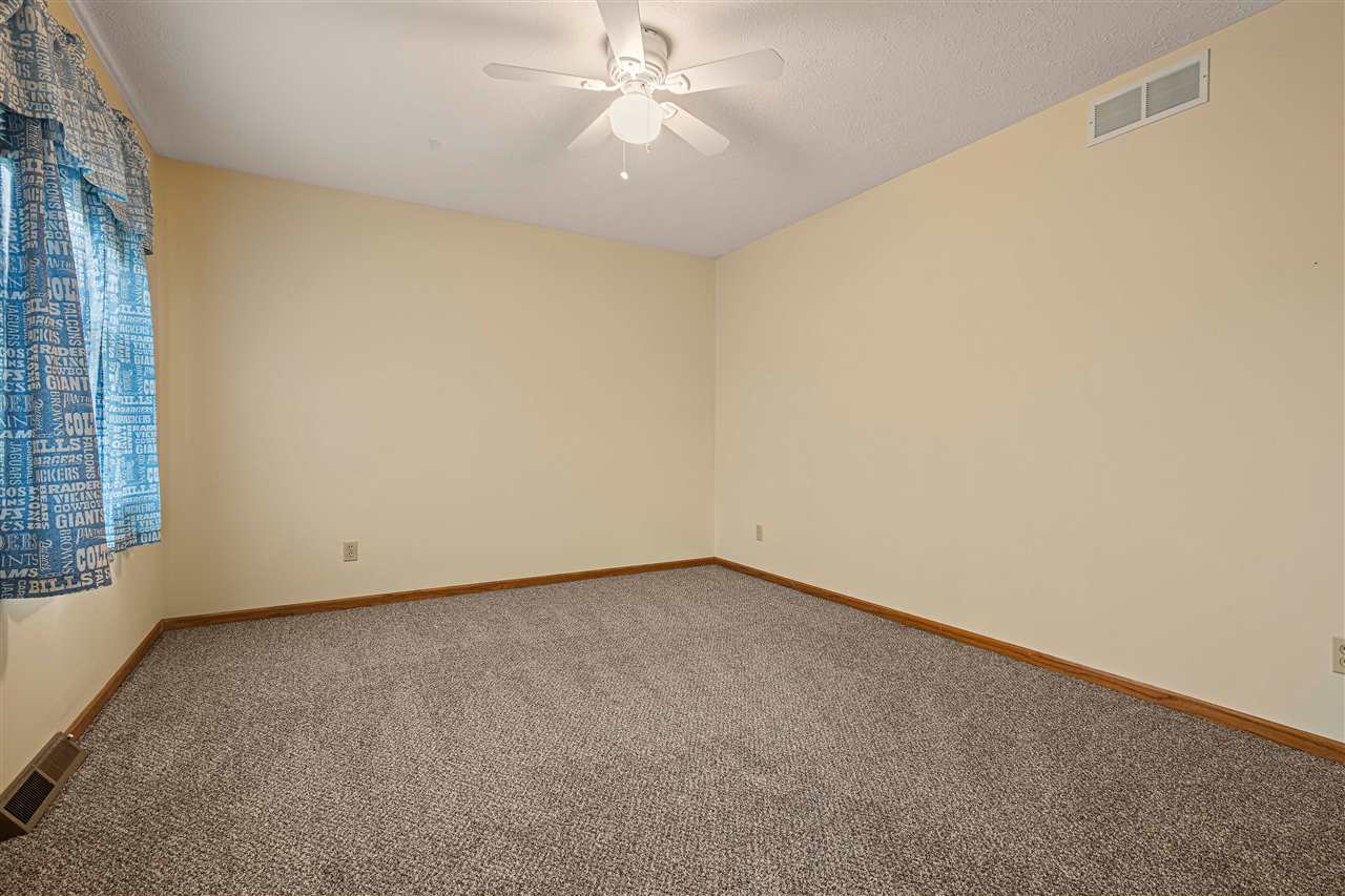 504 Pin Oak Road Rockton, IL 61072 - Photo 18 of 23 an empty room with a window and a ceiling fan