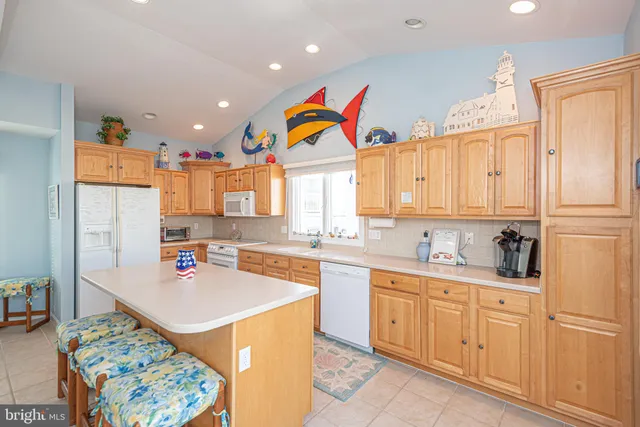 a view of a dining room with furniture and a kitchen