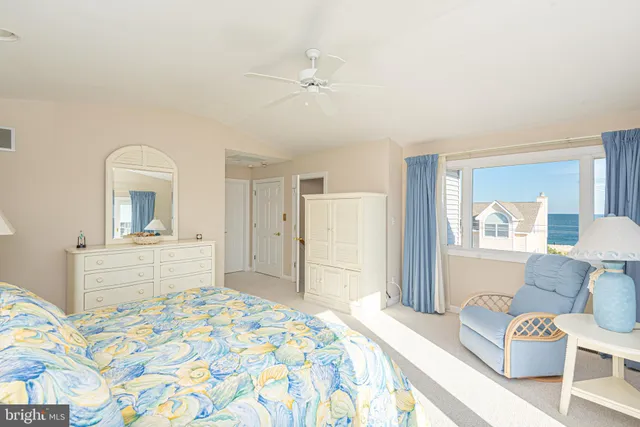 a view of a bedroom with wooden floor and a bathroom