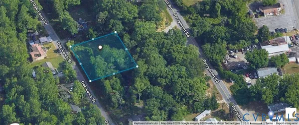 an aerial view of residential houses with outdoor space and trees