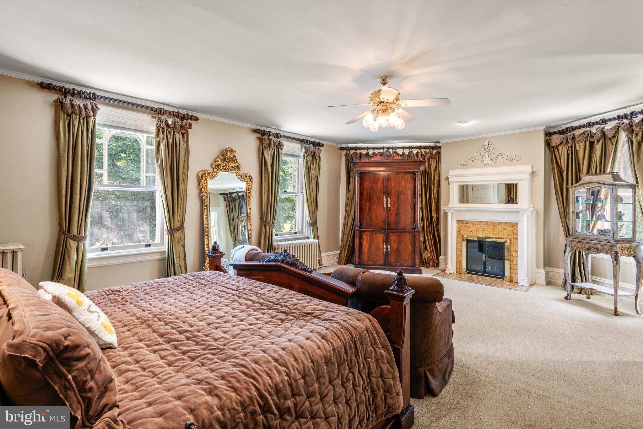 312 South Waterloo Road Devon, PA 19333 - Photo 33 of 70 a spacious bedroom with a balcony a bed and a chandelier