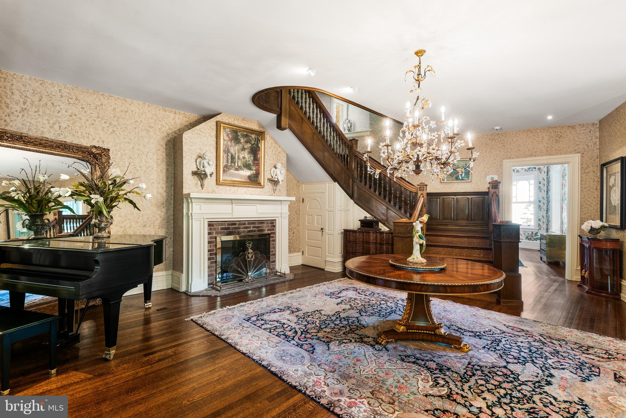 312 South Waterloo Road Devon, PA 19333 - Photo 9 of 70 a living room with furniture a fireplace and a chandelier