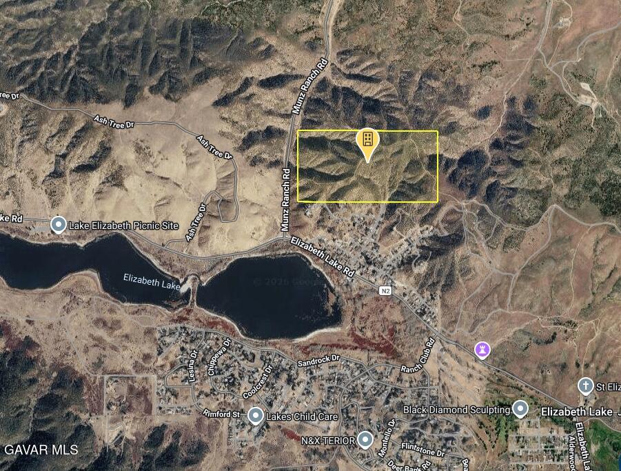 Lake Elizabeth Road Lake Hughes, CA 93532 - Photo 4 of 9 a vase of flowers sitting on top of a bed