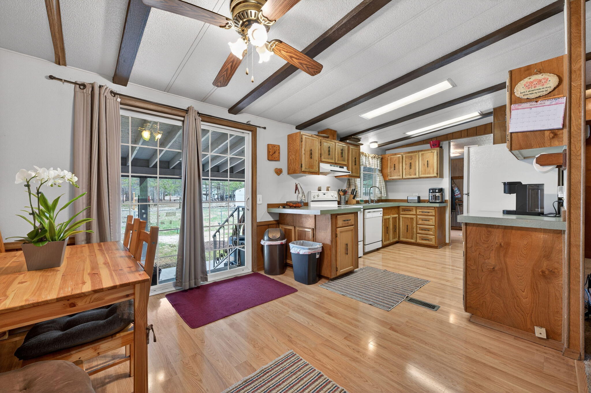 16274 Dyke Road La Pine, OR 97739 - Photo 3 of 20 a kitchen with a refrigerator a stove cabinets and living room view