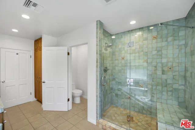 a bathroom with a shower and a glass door