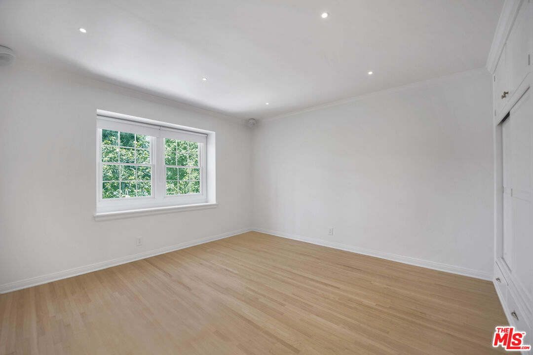 1231 Club View Drive Los Angeles, CA 90024 - Photo 14 of 19 an empty room with wooden floor and windows