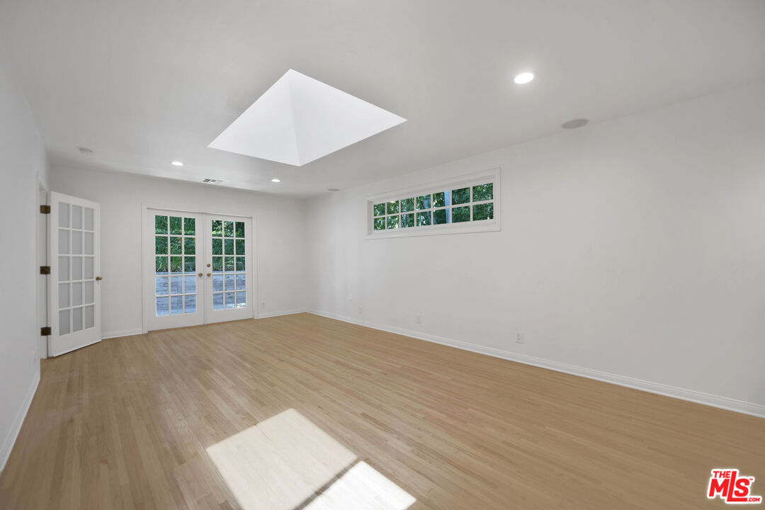 1231 Club View Drive Los Angeles, CA 90024 - Photo 6 of 19 a view of an empty room with wooden floor and a window