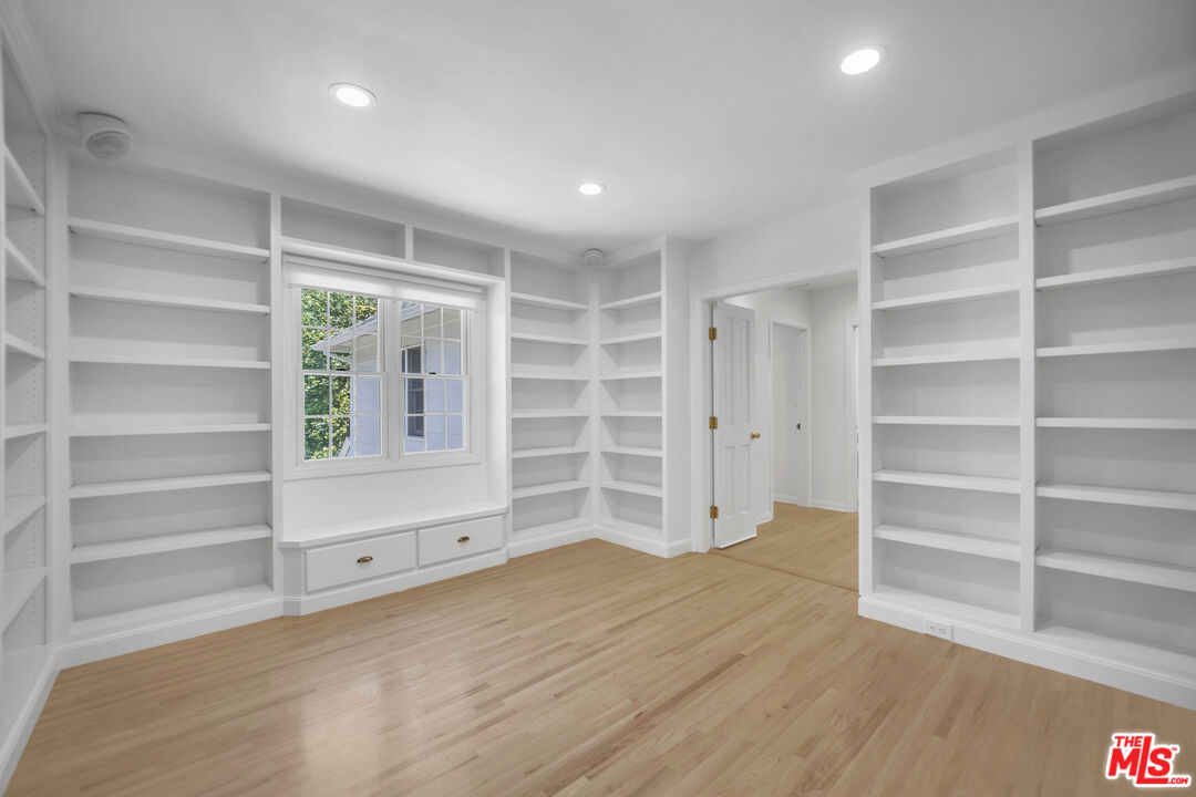 1231 Club View Drive Los Angeles, CA 90024 - Photo 7 of 19 a view of an empty room with a window and wooden shelves