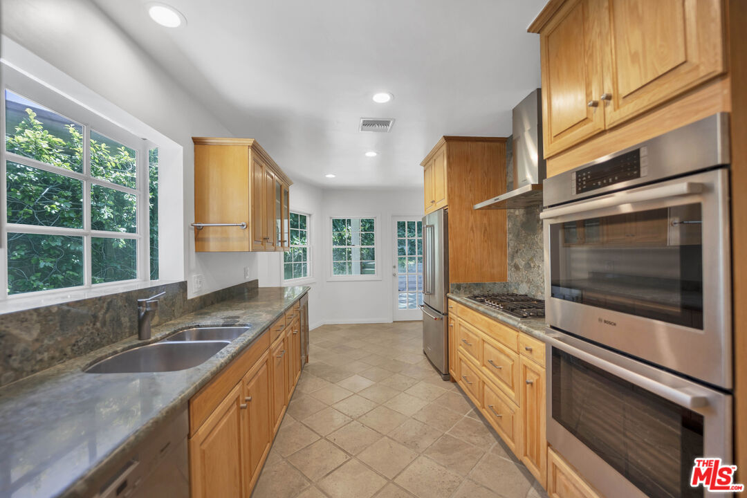 1231 Club View Drive Los Angeles, CA 90024 - Photo 8 of 19 a kitchen with granite countertop a sink and a stove top oven