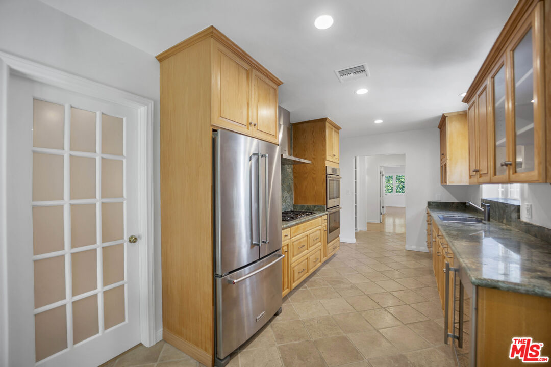 1231 Club View Drive Los Angeles, CA 90024 - Photo 9 of 19 a kitchen with stainless steel appliances granite countertop a refrigerator and a sink
