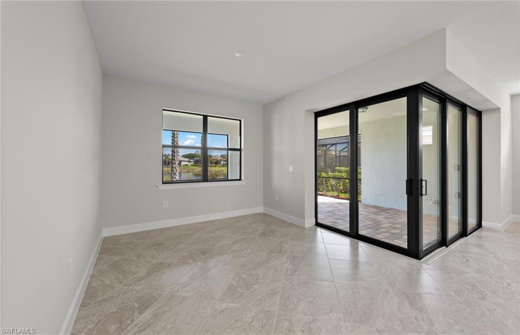 17039 Oakstead Drive Alva, FL 33920 - Photo 15 of 49 an empty room with windows and mountain view