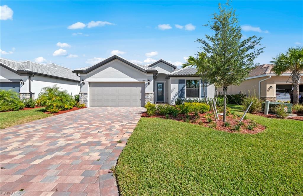 17039 Oakstead Drive Alva, FL 33920 - Photo 2 of 49 a front view of a house with garden and porch