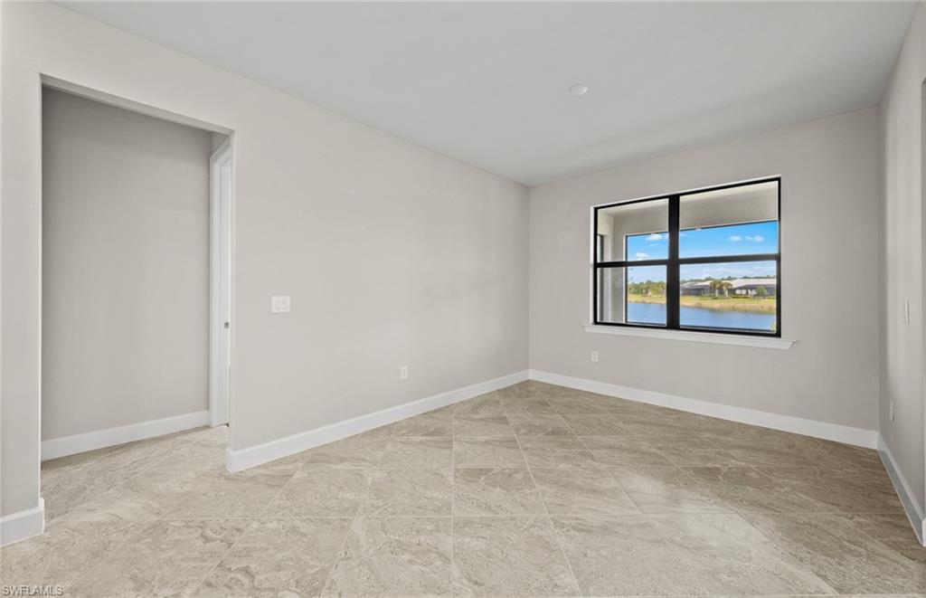 17039 Oakstead Drive Alva, FL 33920 - Photo 21 of 49 an empty room with windows and fireplace