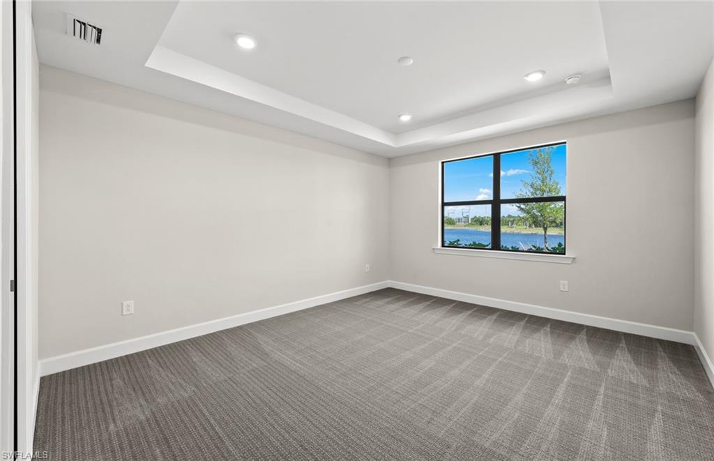 17039 Oakstead Drive Alva, FL 33920 - Photo 23 of 49 an empty room with wooden floor and windows